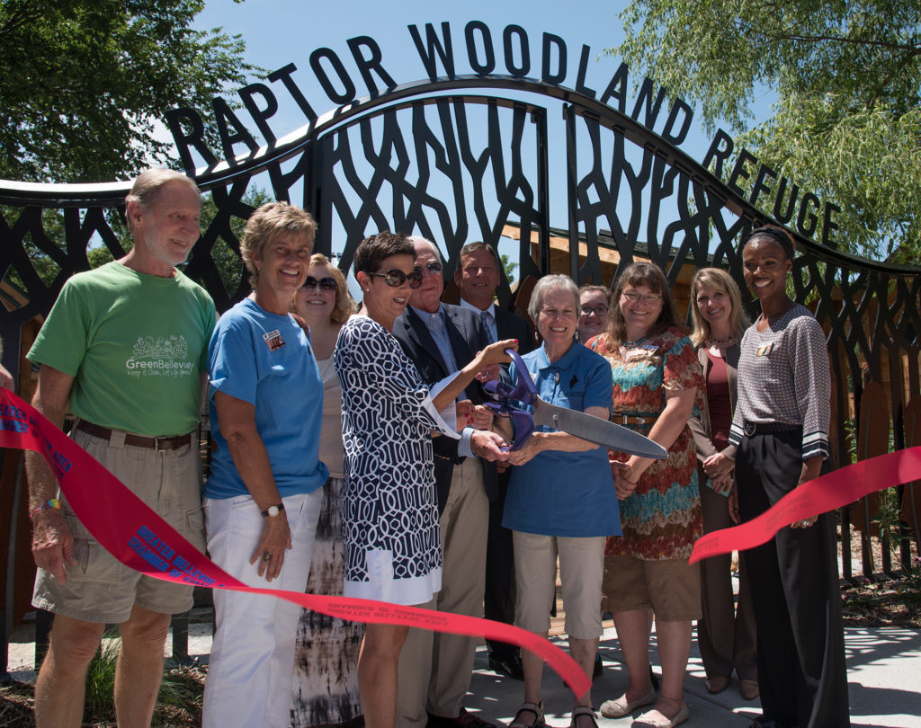 Group of people cutting the opening ribbon of Raptor woodland refuge 