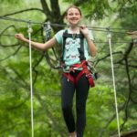 Child partaking in the tree rush ropes course
