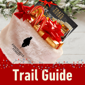 a picture of a gift card on a white tree skirt. It has a red banner with the white text, "Trail Guide"