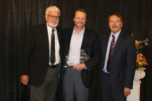 An image of John Ricks, Nebraska Tourism Executive Director; Matt Darling, Fontenelle Forest Executive Director; and Roger Jasnoch, Nebraska Tourism Commissioner Chair accepting the 2021 Outstanding Ecotourism Entity Award.